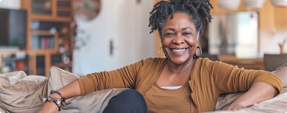 woman smiling while sitting on a couch