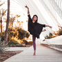 Barefoot woman ballet dancing near beautiful outdoors area